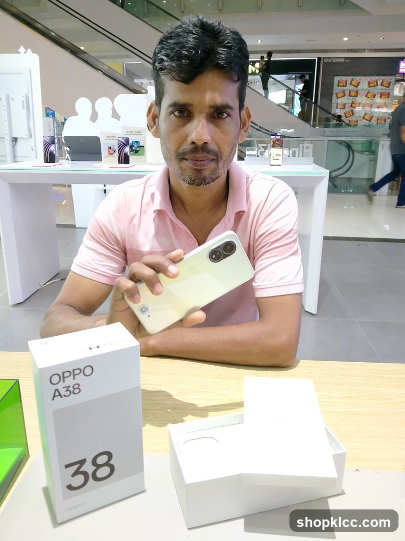 Man holding a smartphone with its box