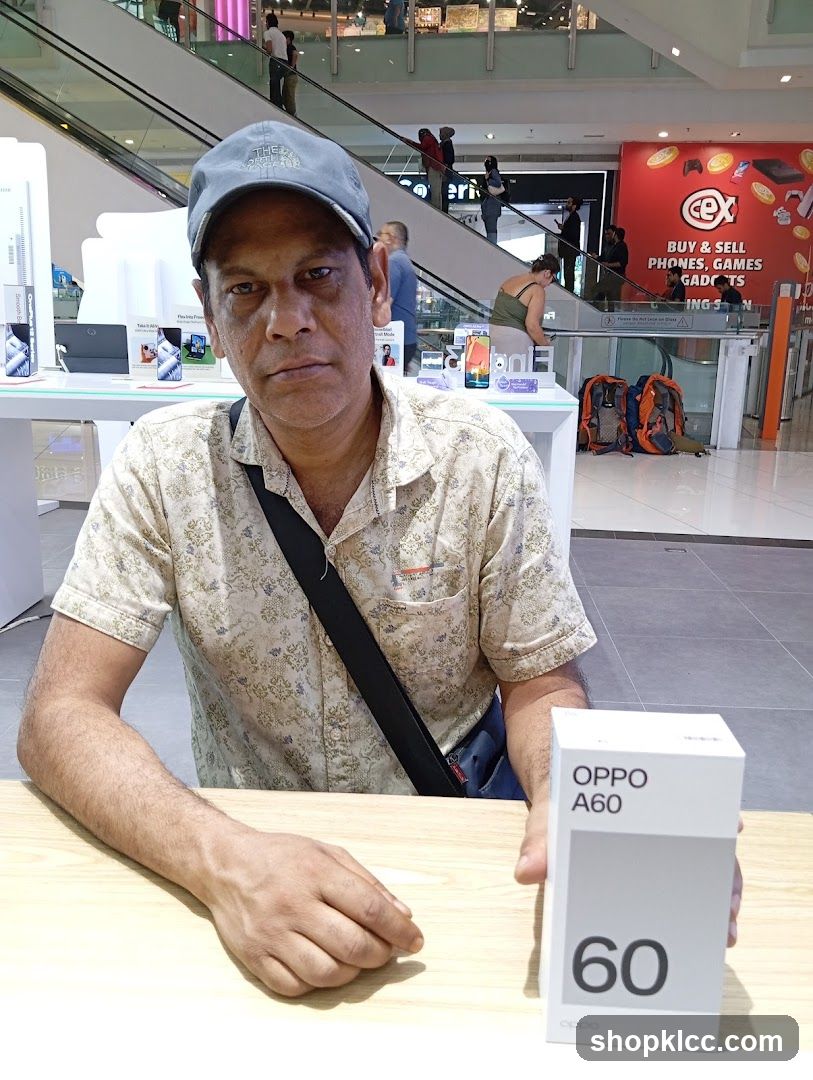 Man holding an Oppo A60 box