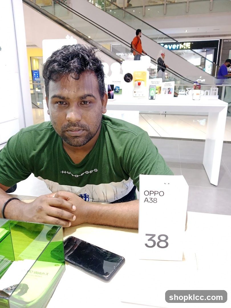 Man sitting at a table with a phone and product box