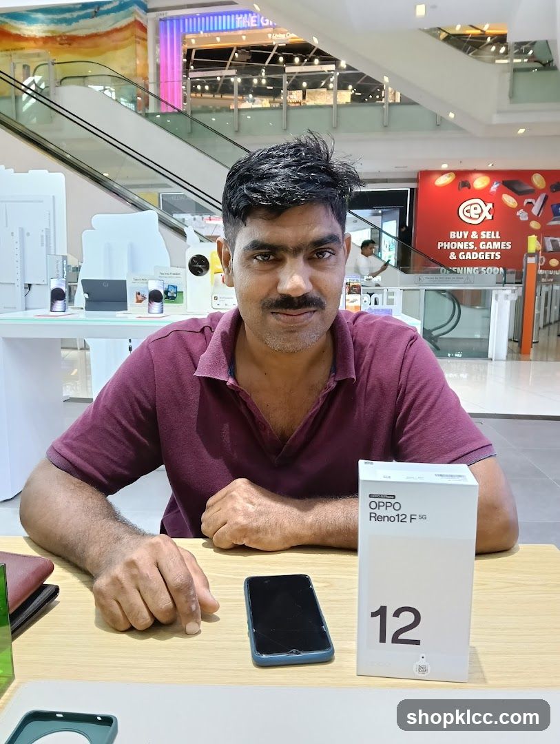 Man with OPPO Reno12 F 5G box