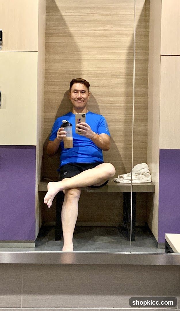 Man in locker room with protein shake