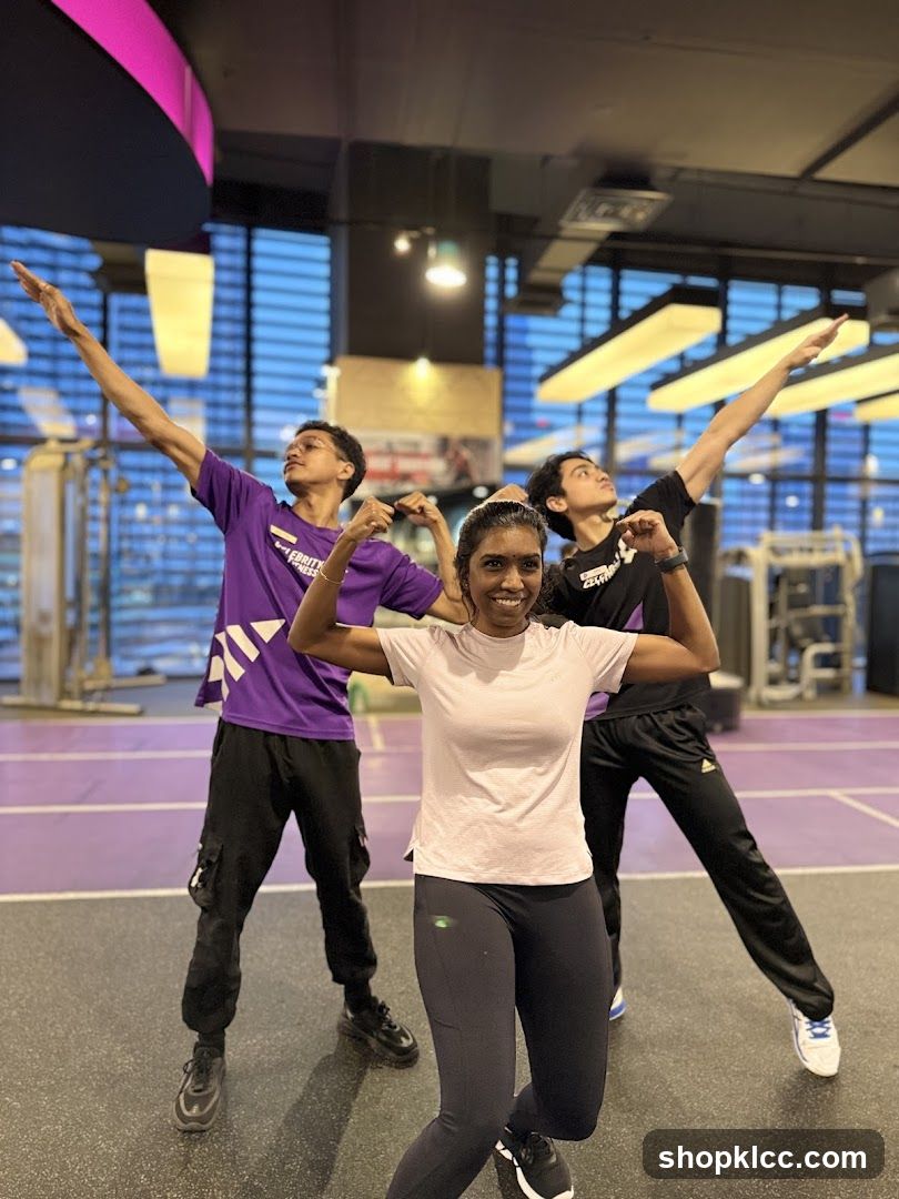 Three people posing in a gym