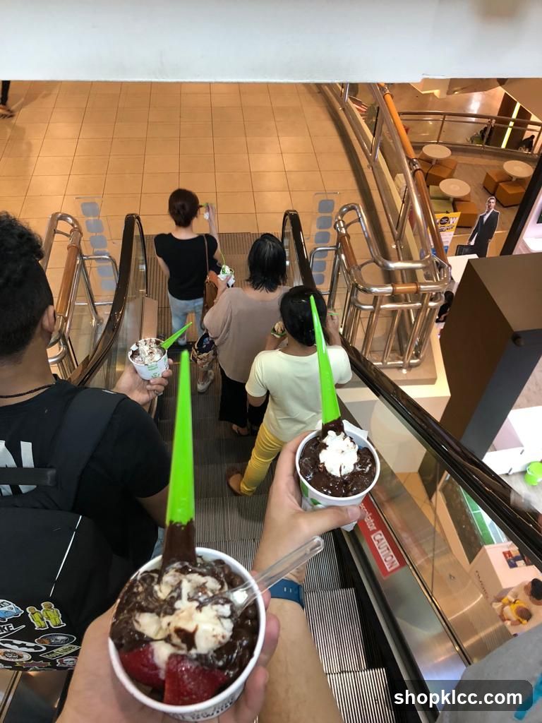 People on Escalator with Desserts