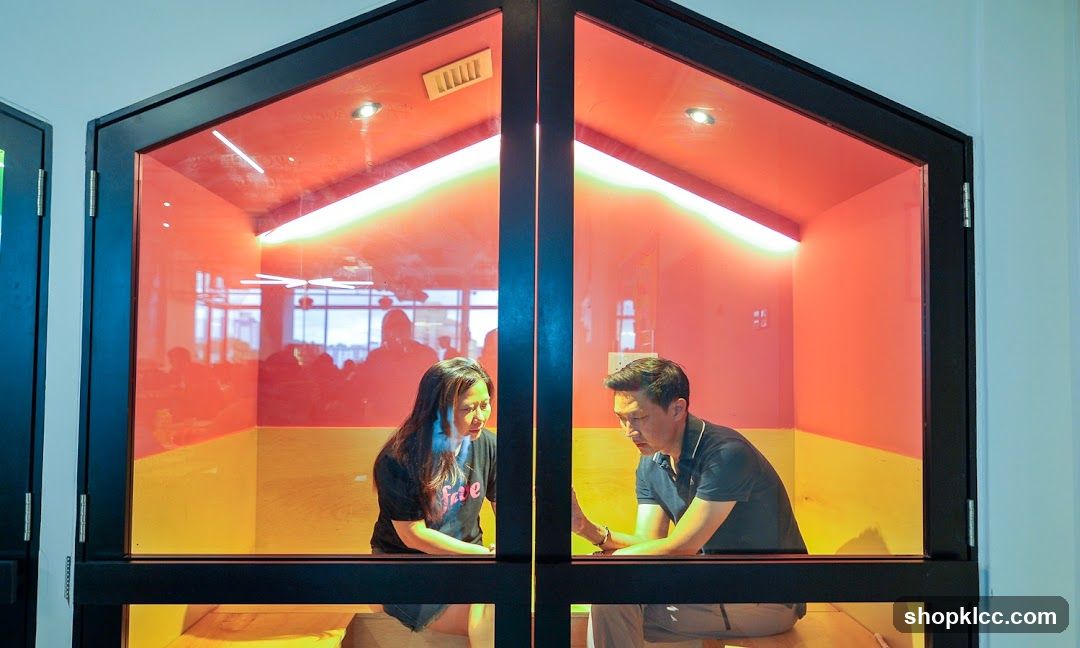 People in a brightly lit booth