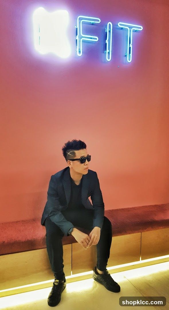 Man Posing in Front of Neon Sign