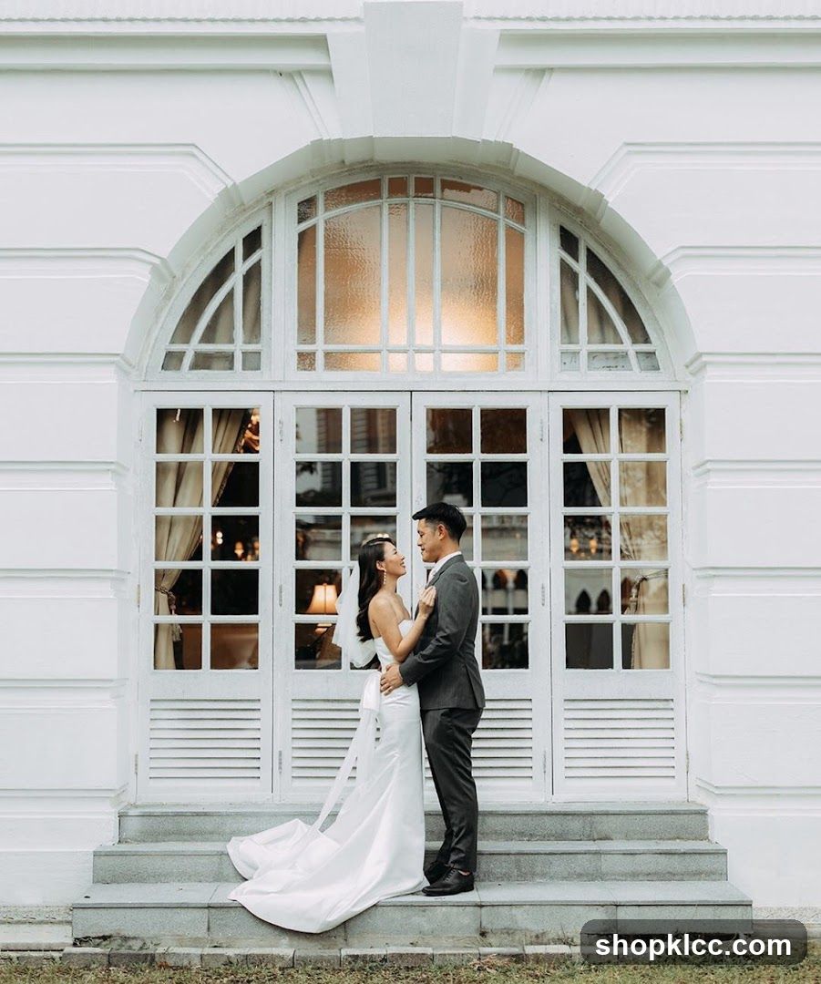 Wedding Couple Posing in Front of White Arched Doors