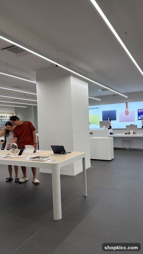 Customers browsing electronics in a modern store