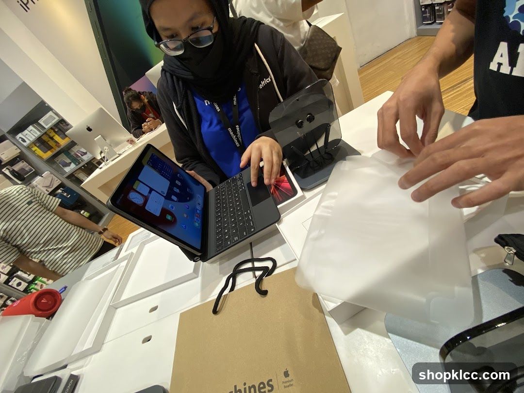 Customers interacting with electronics in a store