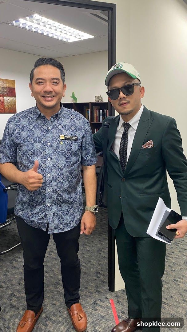 Two men posing for a photo in an office