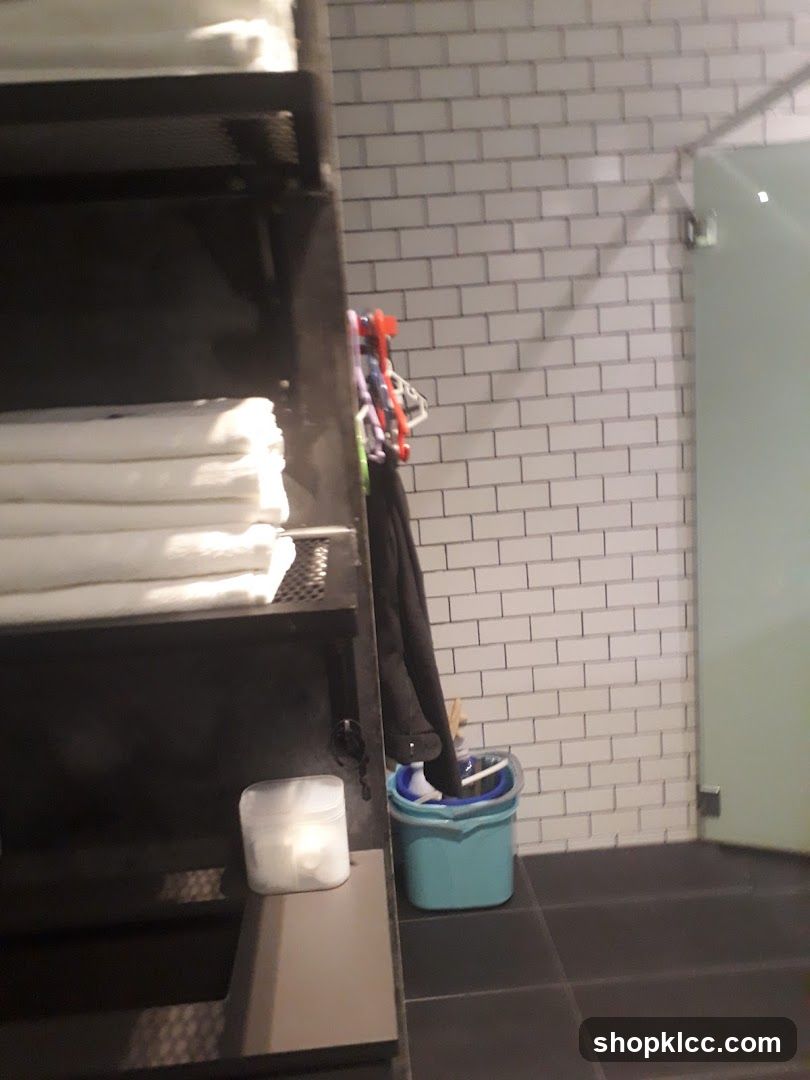 Bathroom Interior with Towels and Cleaning Supplies
