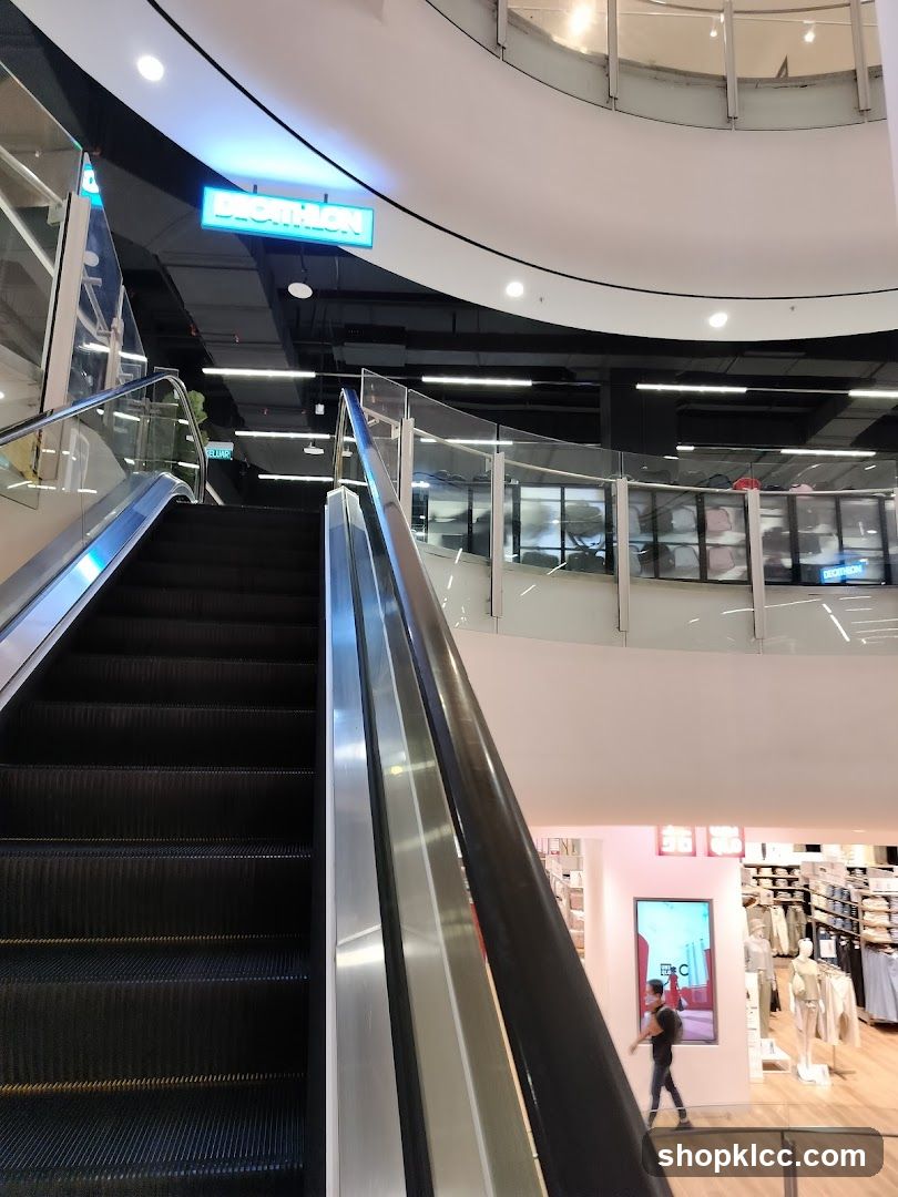 Escalator in a mall with store signage