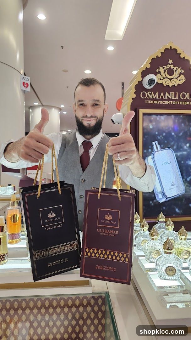 Man holding shopping bags with perfumes