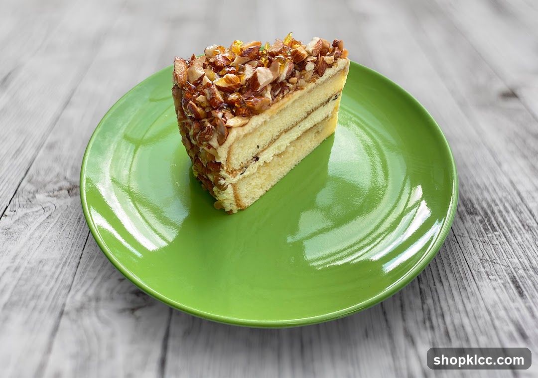 Slice of layered cake with caramelized topping on green plate