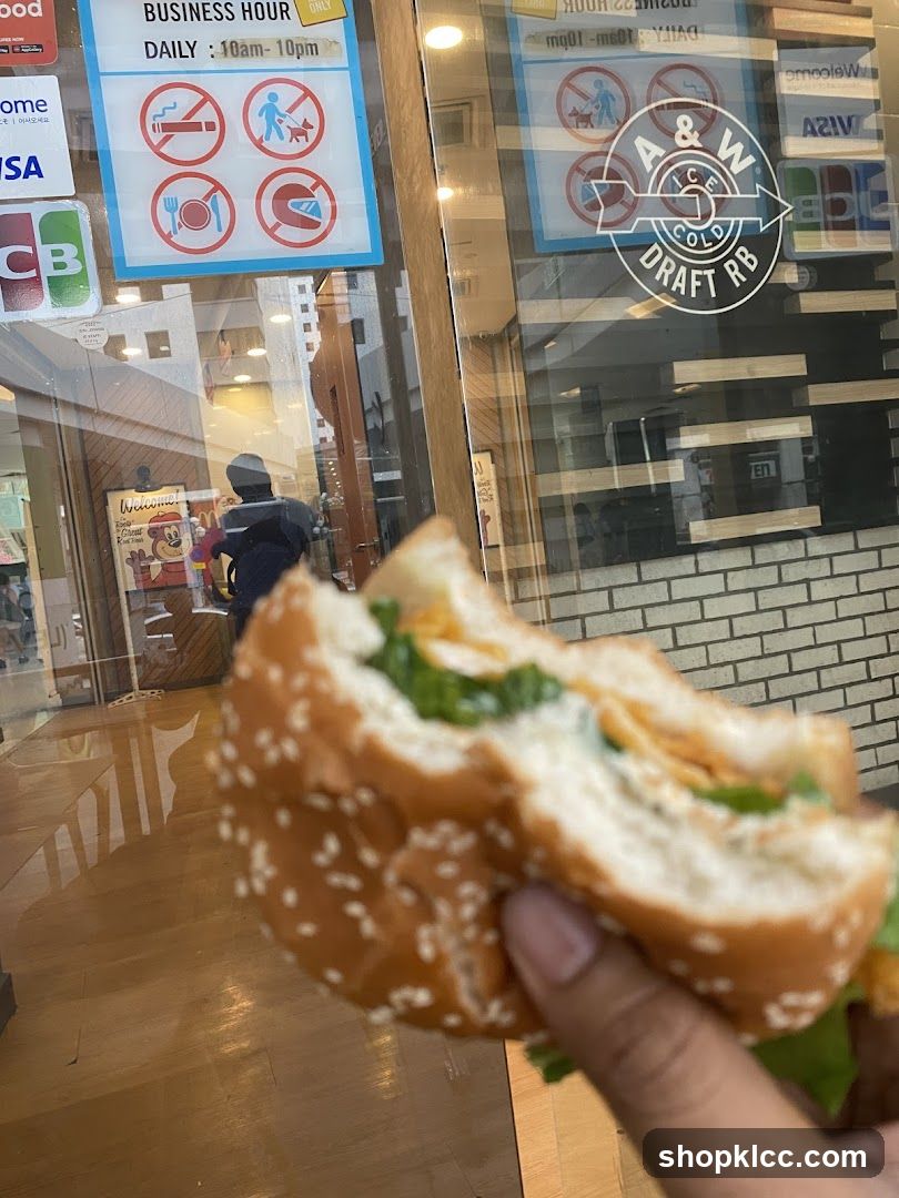 Burger in hand near storefront