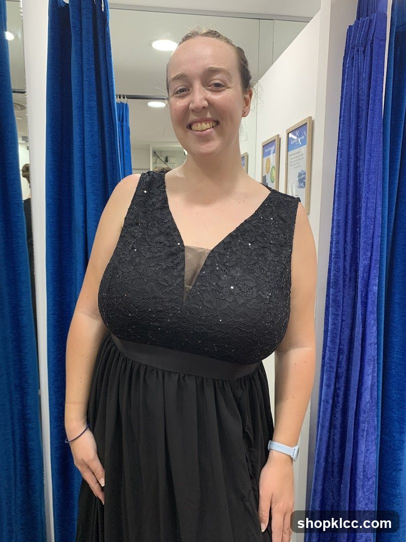 Woman in a black dress in a fitting room