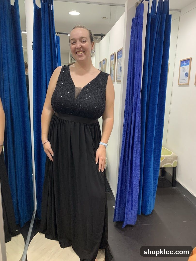 Woman in a black dress in a fitting room