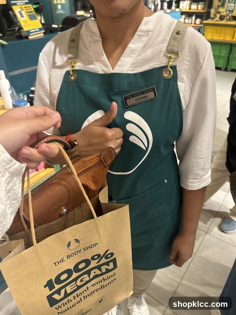 The Body Shop employee with shopping bag