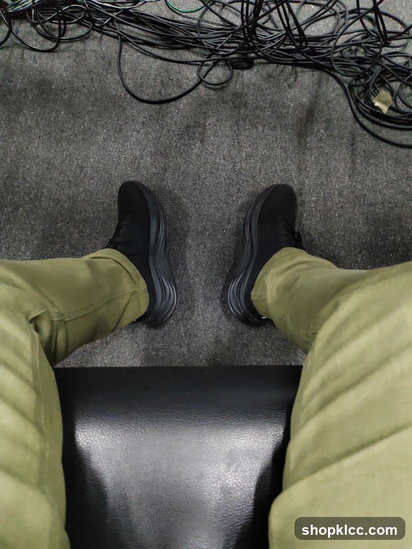 Person wearing black shoes and green pants