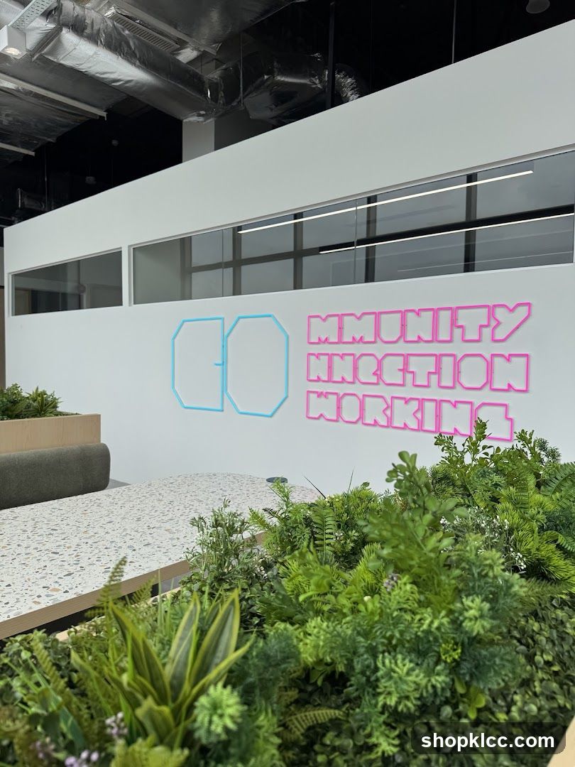 Office Interior with Neon Signage and Greenery