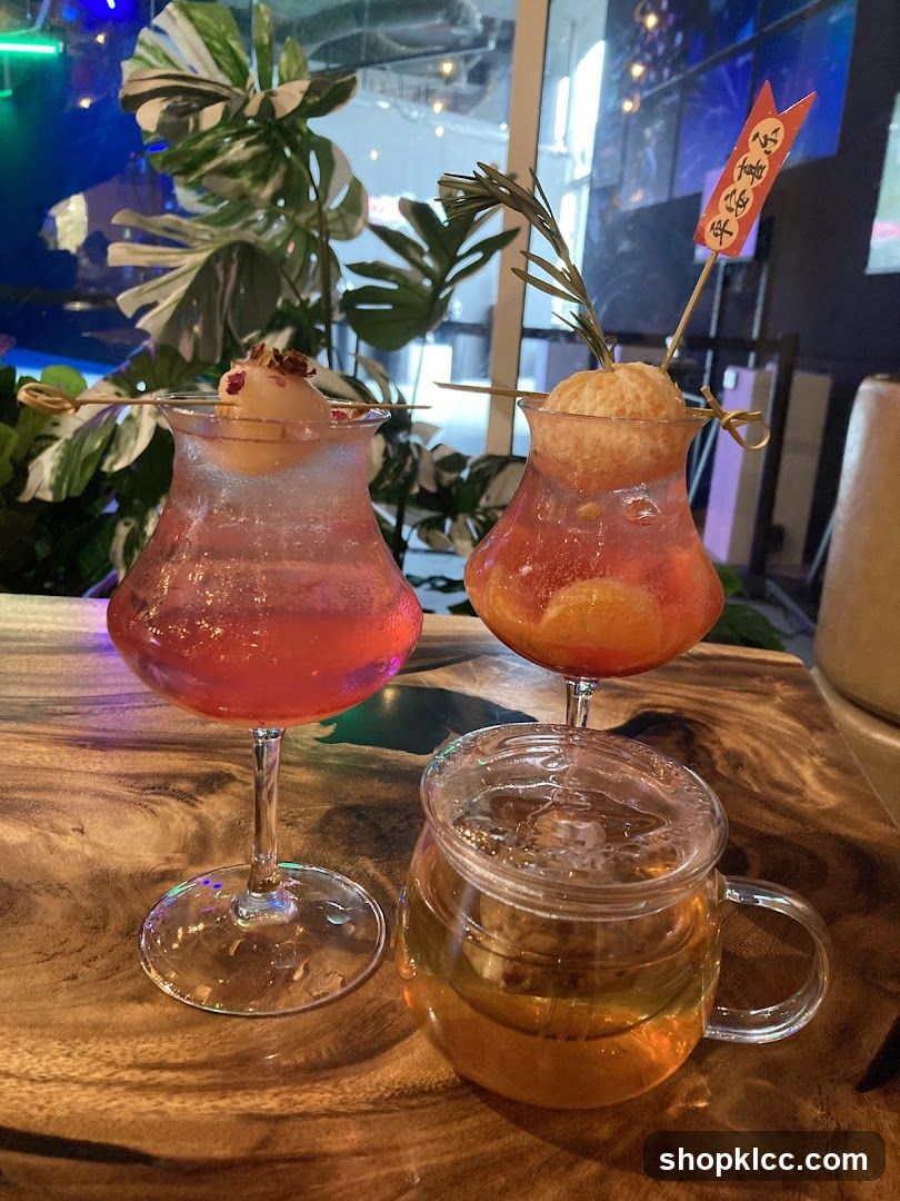 Two colorful cocktails and a tea in a glass mug