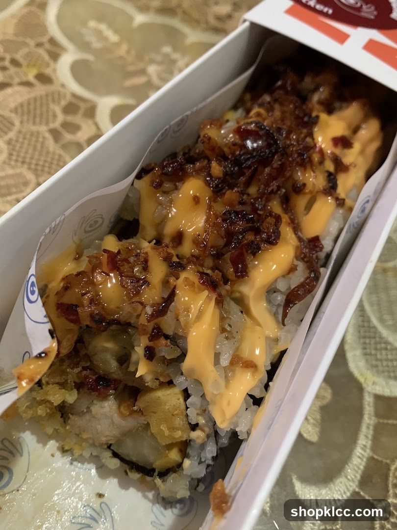 Sushi roll with sauce and toppings