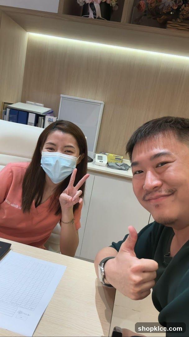 Two people posing for a selfie in an office