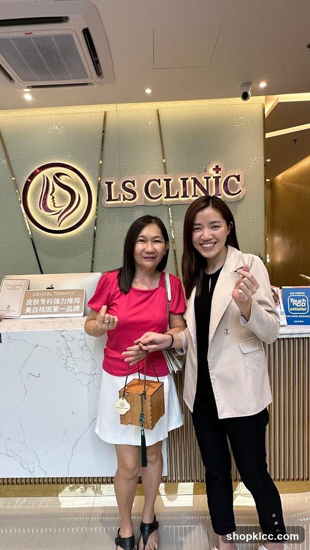 Two women posing in front of LS CLINIC