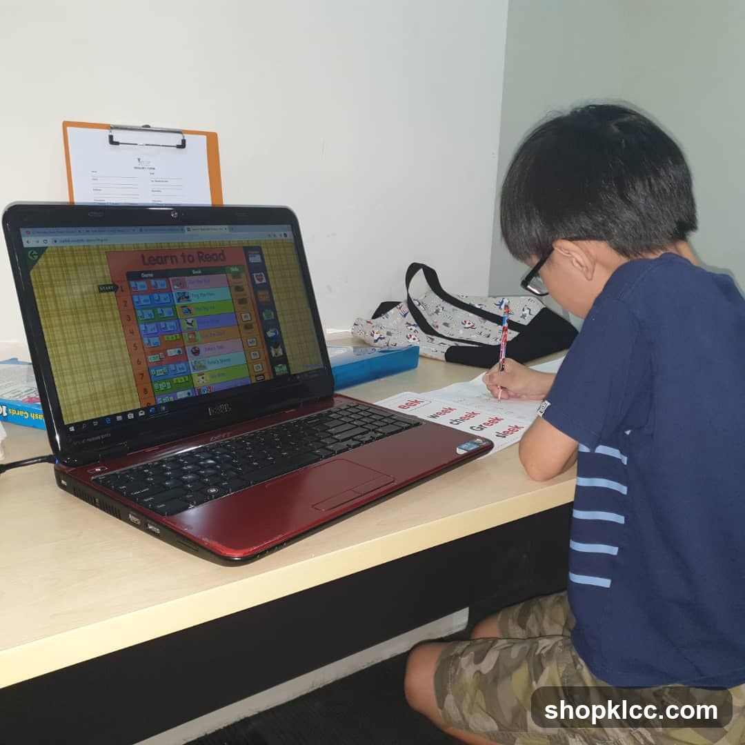 Child learning to read on laptop