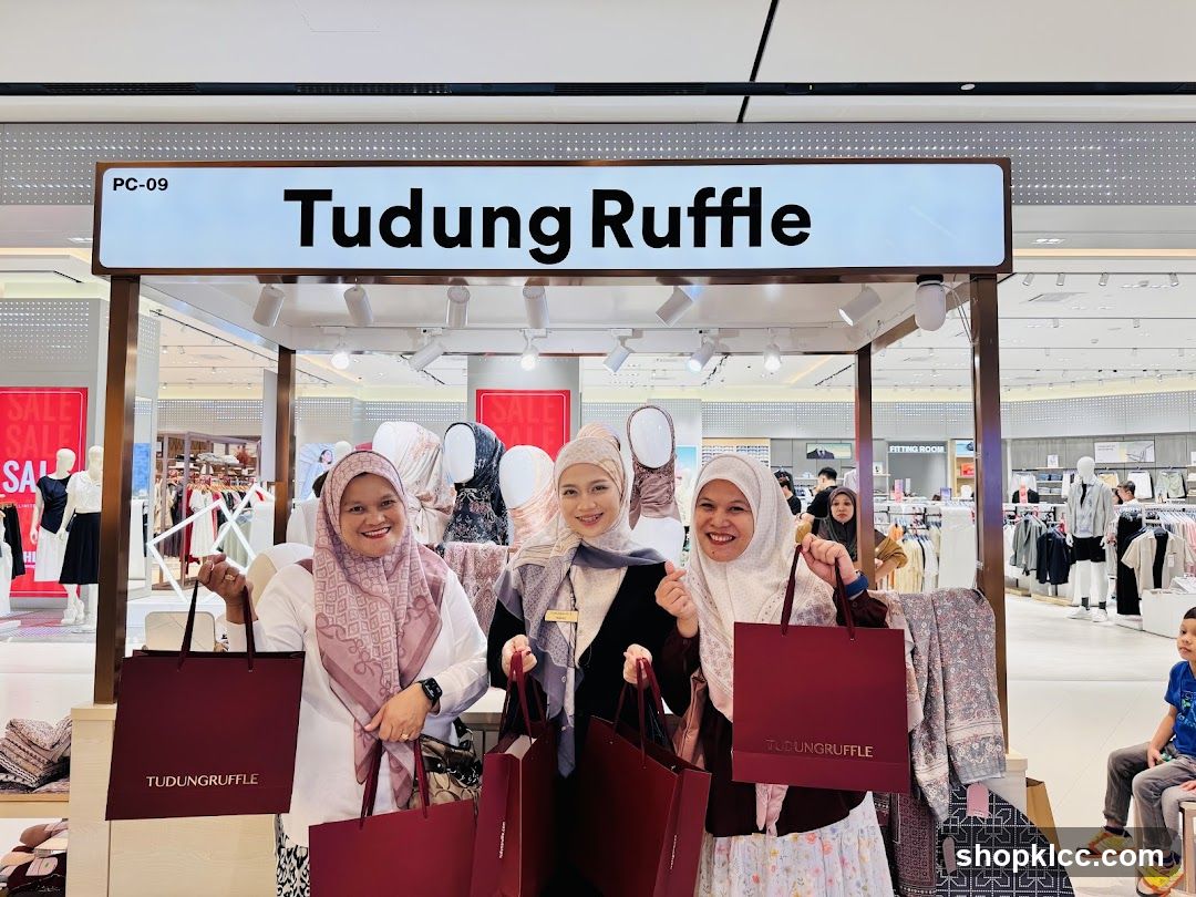Women Posing with Shopping Bags at Tudung Ruffle