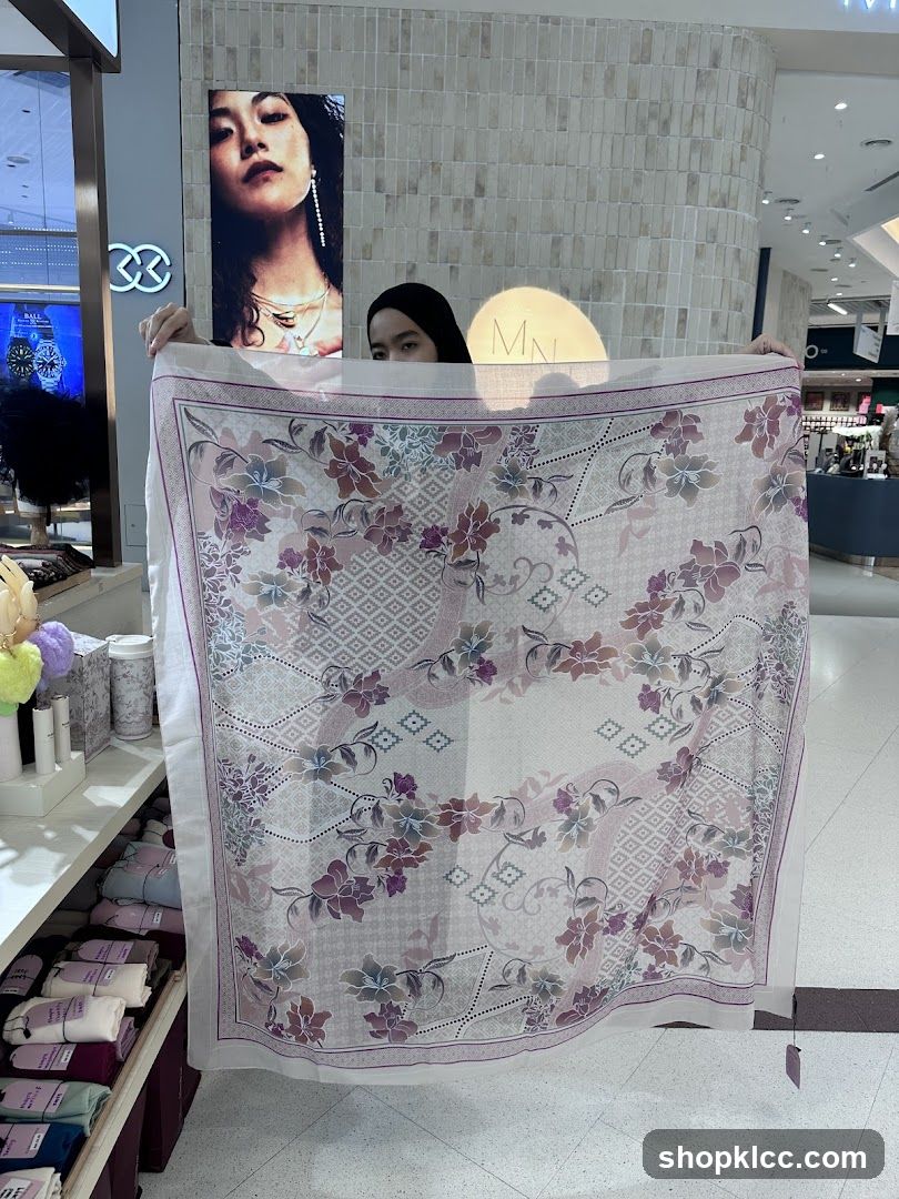 Woman holding a patterned scarf
