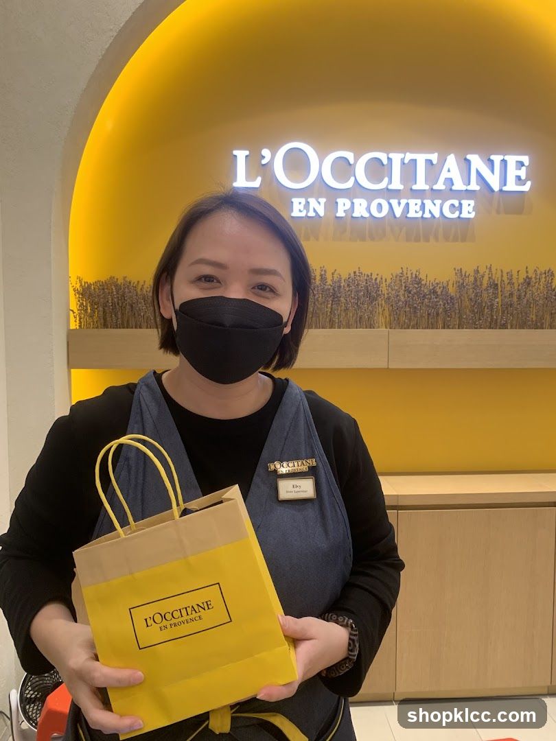 L'Occitane employee with shopping bag