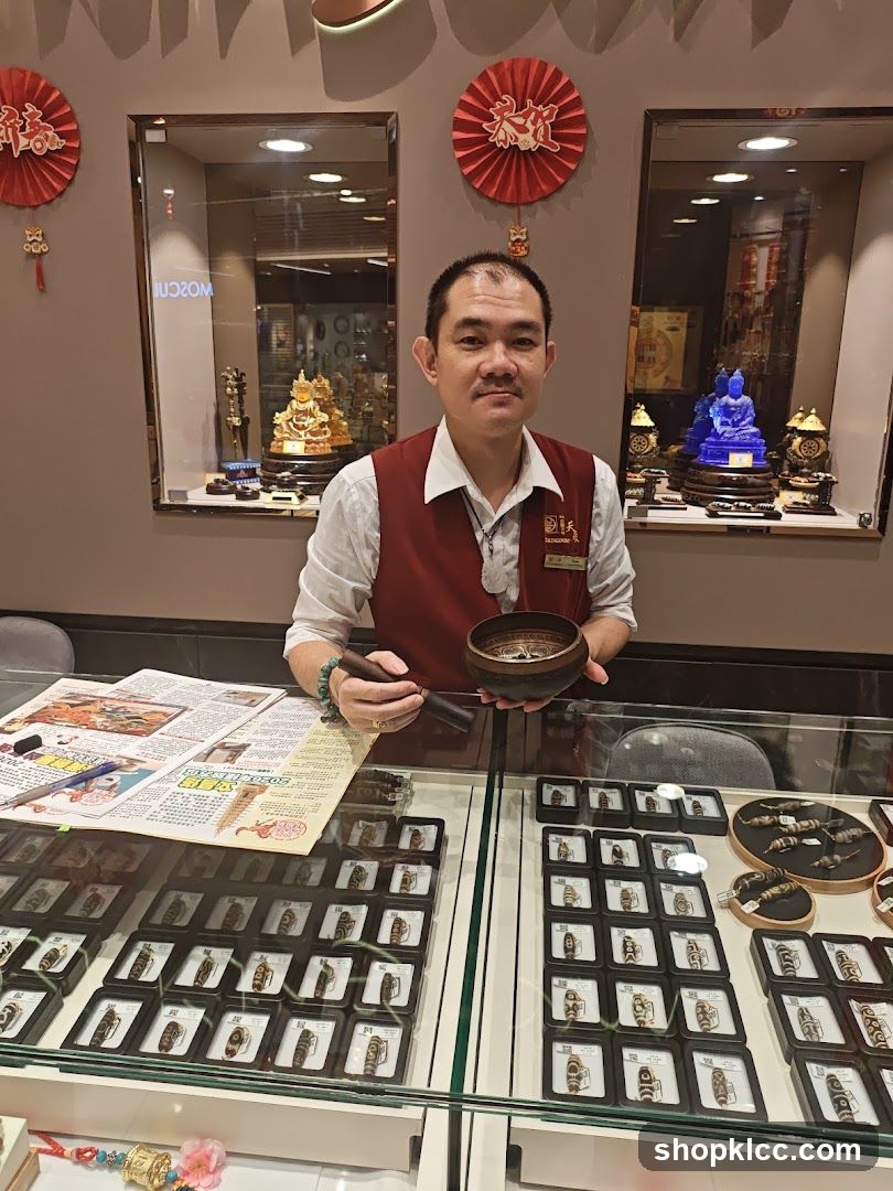 Shopkeeper holding a bowl and stick