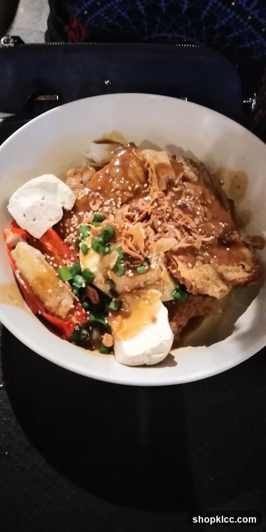 Bowl of food with sauce and toppings