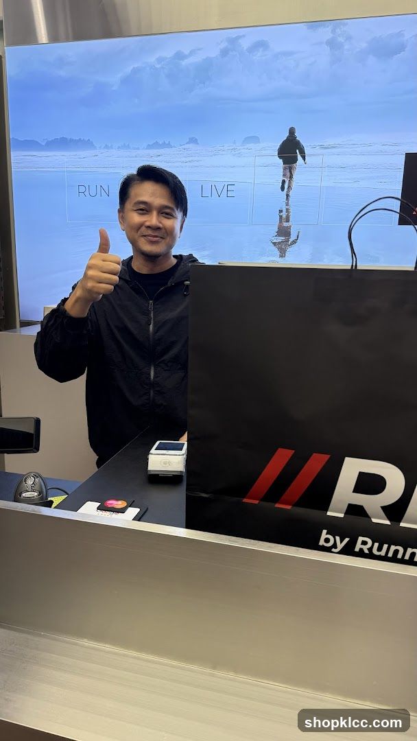 Man giving a thumbs up at a counter
