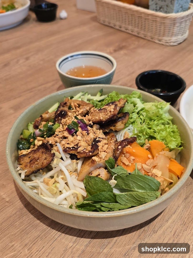 Bowl of Vietnamese-style noodle dish with toppings