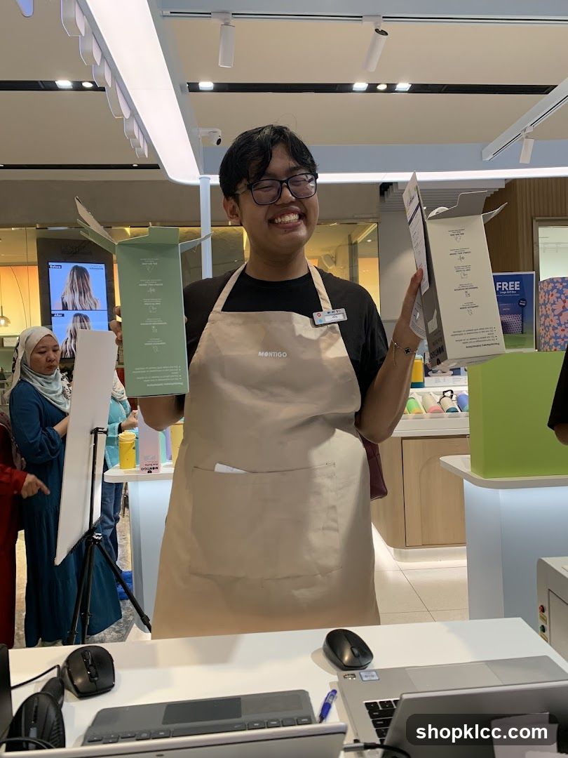 Smiling employee holding product boxes