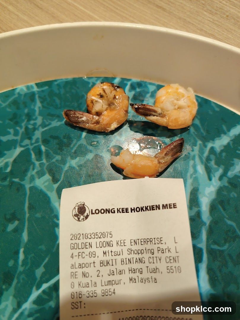 Shrimp on a plate with receipt