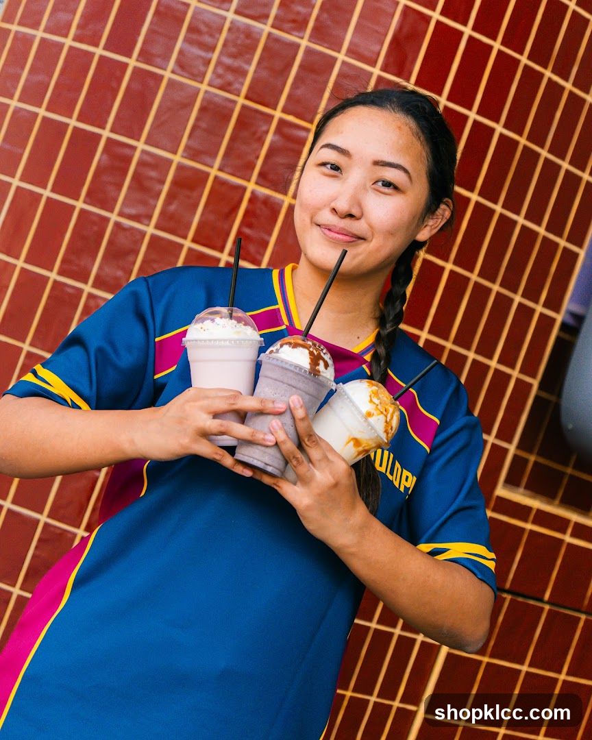 Woman Holding Milkshakes