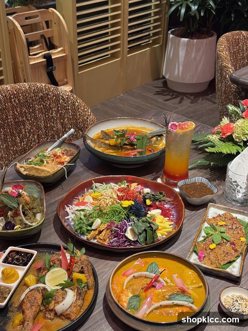 Table with various Thai dishes and a drink