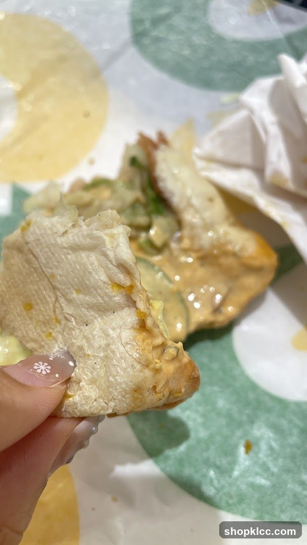 Half-eaten sandwich with sauce