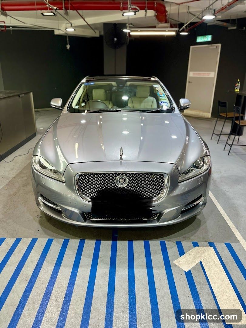 Silver Jaguar parked in a garage