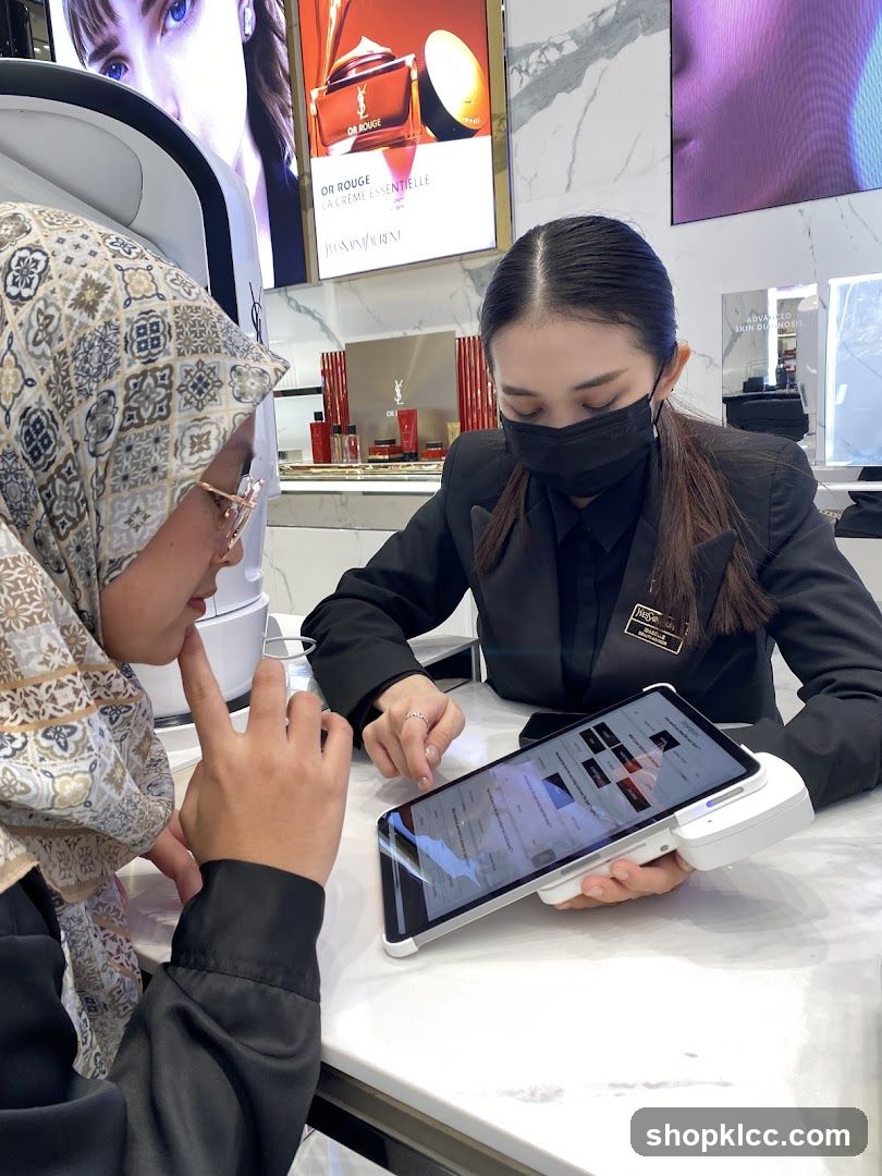 Sales associate assisting customer with a tablet