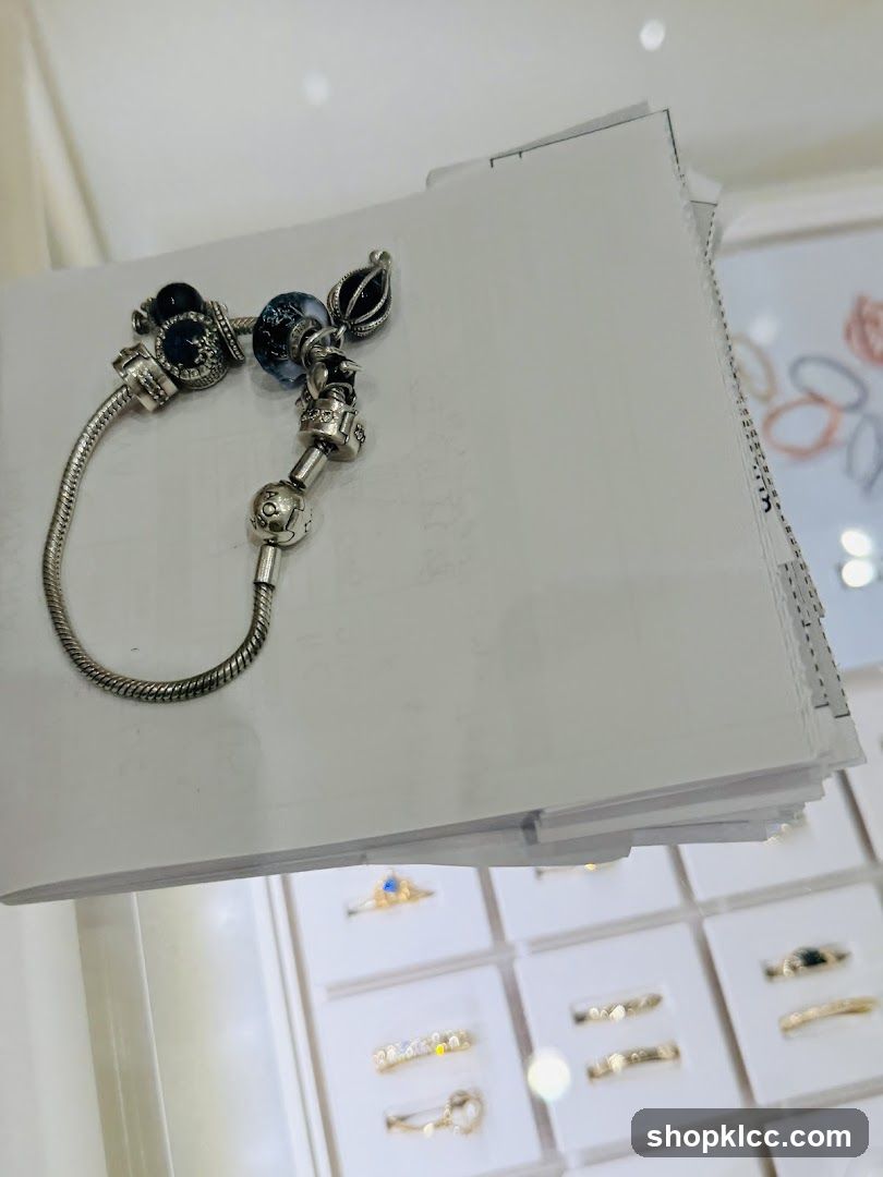 Bracelet with charms and display of rings