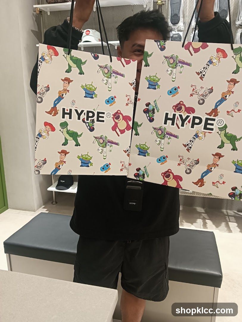 Person holding shopping bags with Toy Story characters