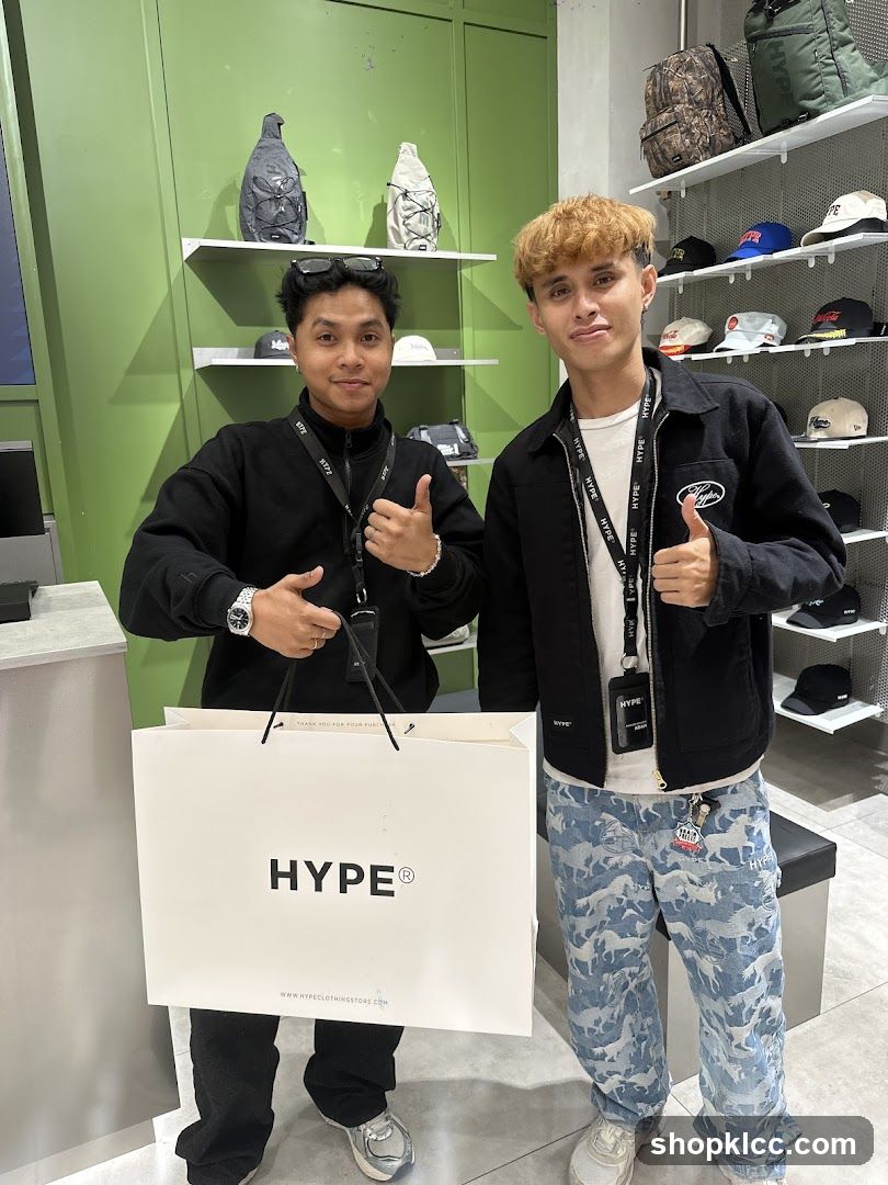 Two men holding a shopping bag
