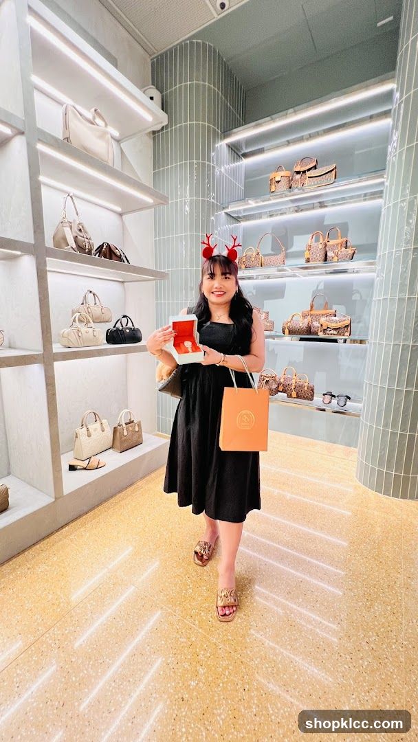 Woman holding a watch box in a handbag store