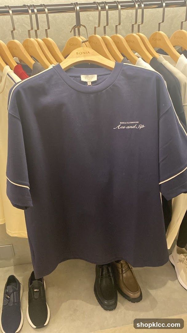 Navy T-shirt with white trim and embroidered text