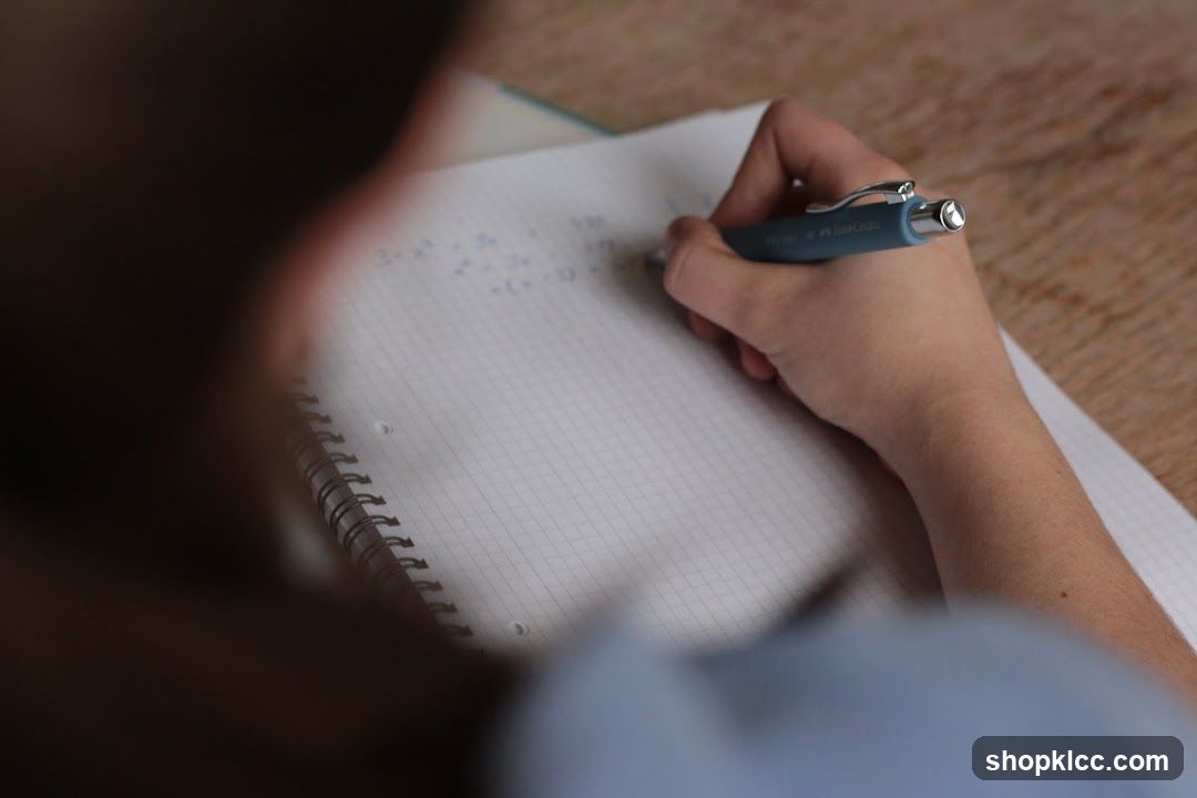 Person Writing in Notebook