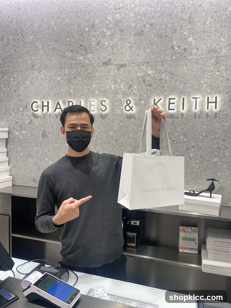 Man holding a shopping bag in a store