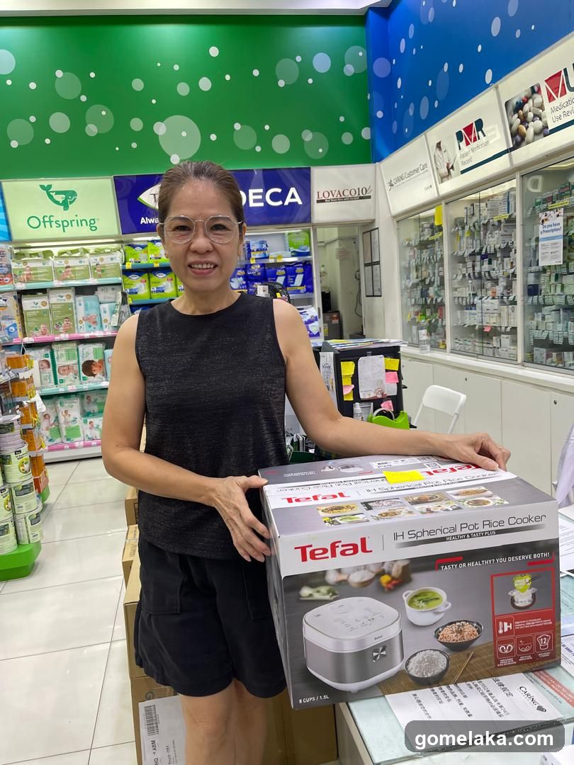 Customer in pharmacy holding rice cooker box